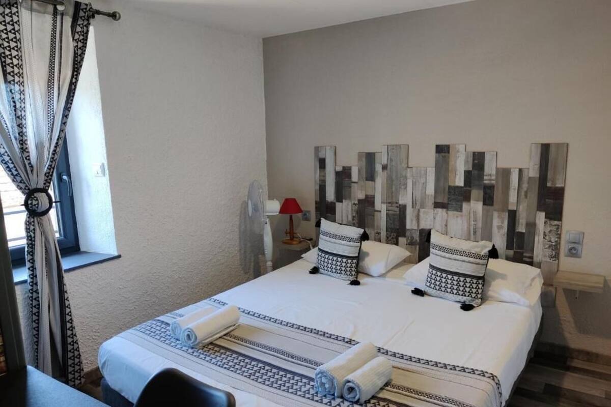 Premium bedding, desk, laptop workspace, blackout drapes