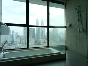 A modern bathroom with a large window, a bathtub, and a shower. - Setia Sky by Urban Homes (Kuala Lumpur)
