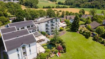 A residential area with modern houses, a swimming pool, and well-maintained lawns.