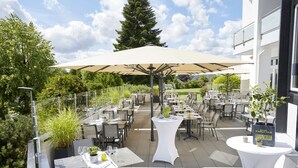 An outdoor dining area with tables and chairs, a large umbrella, and a sign that reads "DON PASQUALE LAMUNCELLO". - Hotel Derichsweiler Hof (Nümbrecht)