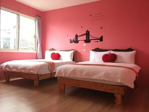 A room with two wooden beds, pink walls, and a window with a view of buildings. - Huixin Lanyuan (Yuchi)
