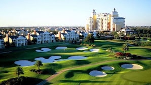 A golf course with bunkers and a clubhouse. - Reunion Resort Townhome - minutes from Disney! (Reunion)