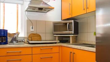 Fridge, microwave, cookware/dishes/utensils, dining tables