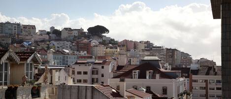 A cityscape with a variety of buildings, including residential and possibly commercial structures.