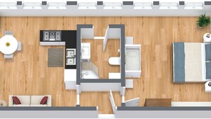 A modern apartment layout with a kitchen, dining area, living room, and a bedroom.
