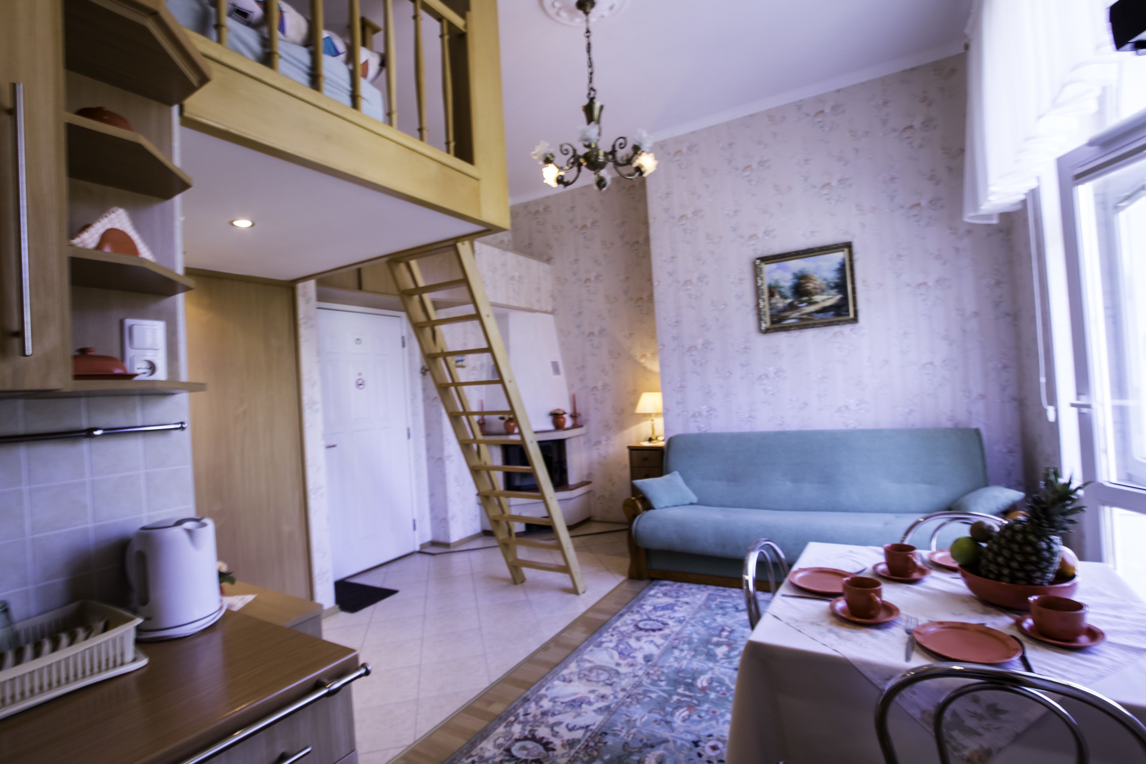 Un espace de vie compact comprenant une cuisine, un coin repas et un escalier.