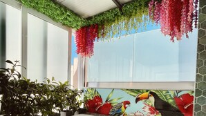 A modern bathroom with a large bathtub, green plants, and a colorful mural. - Athens Starlight Hotel (Athens)