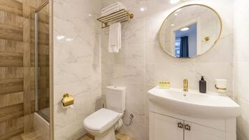 Une salle de bain moderne équipée de toilettes, d’un lavabo et d’une douche.
