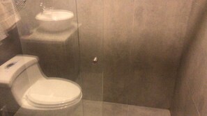 A bathroom with a toilet, sink, and shower stall. - Walkable to Downtown/Stadium/Hosp. St Ines. 360 View of Cuenca - Room + Terrace (Cuenca)