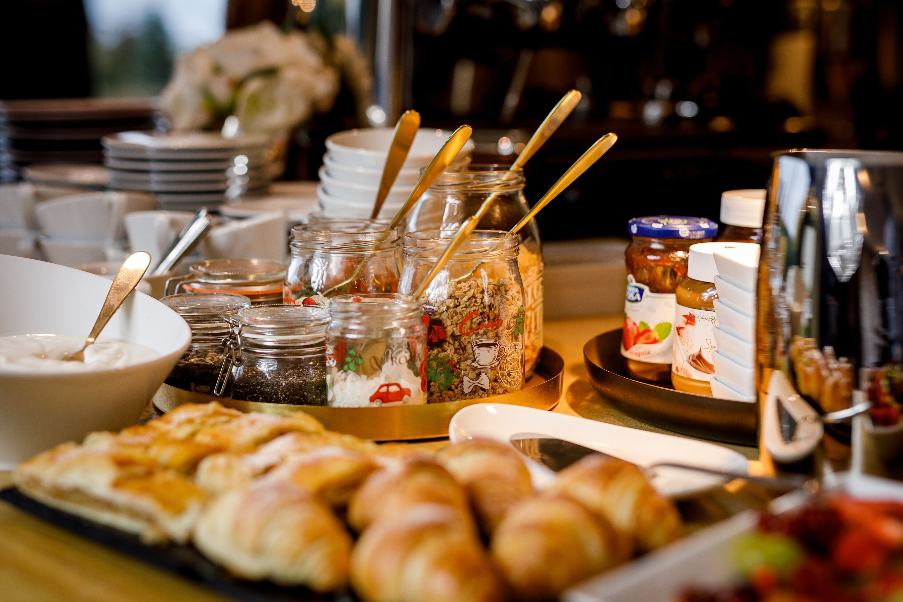 A breakfast buffet with various food items and condiments.