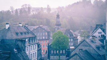 A historic town with traditional architecture, including half-timbered houses and a church with a prominent dome.