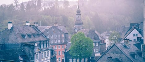 A historic town with traditional architecture, including half-timbered houses and a church with a prominent dome.
