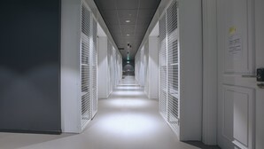 A long, narrow hallway with white doors on both sides, leading to a room at the end. - Park Hotel Tsinandali Estate (Telavi)