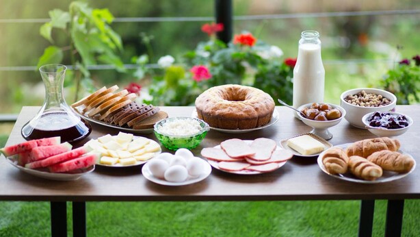 A breakfast table with various food items including bread, eggs, cheese, and pastries. - Park Hotel Tsinandali Estate (Telavi)
