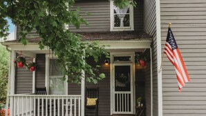 A porch with a white railing, a bench, and a potted plant. - Large home, Pet friendly (Union)
