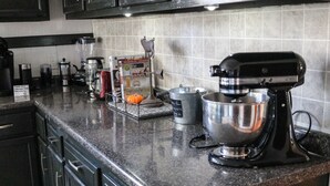 A kitchen with a mixer, a coffee maker, and a pumpkin on the counter. - Large home, Pet friendly (Union)