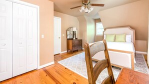 A bedroom with a bed, wooden floor, ceiling fan, and a dresser. - Stunning Rushing River Views  ~ North Georgia Mountains ~ Short Hop to Town! (Dahlonega)