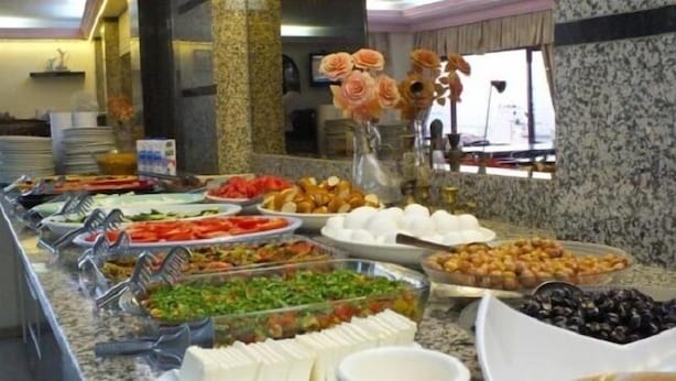 A buffet with various food items including fruits, vegetables, and pastries. - Naz Hotel (Istanbul)