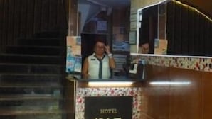 A hotel reception desk with a sign reading "NAZ HOTEL" and a sign below it stating "HOTEL NAZ". - Naz Hotel (Istanbul)