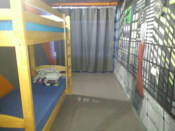 A bunk bed room with a curtain, a tiled wall, and a window. - Graffiti Mega City Hostel (Kyiv)