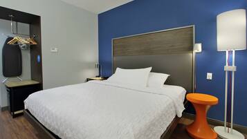 Escritorio, cortinas blackout y tabla de planchar con plancha