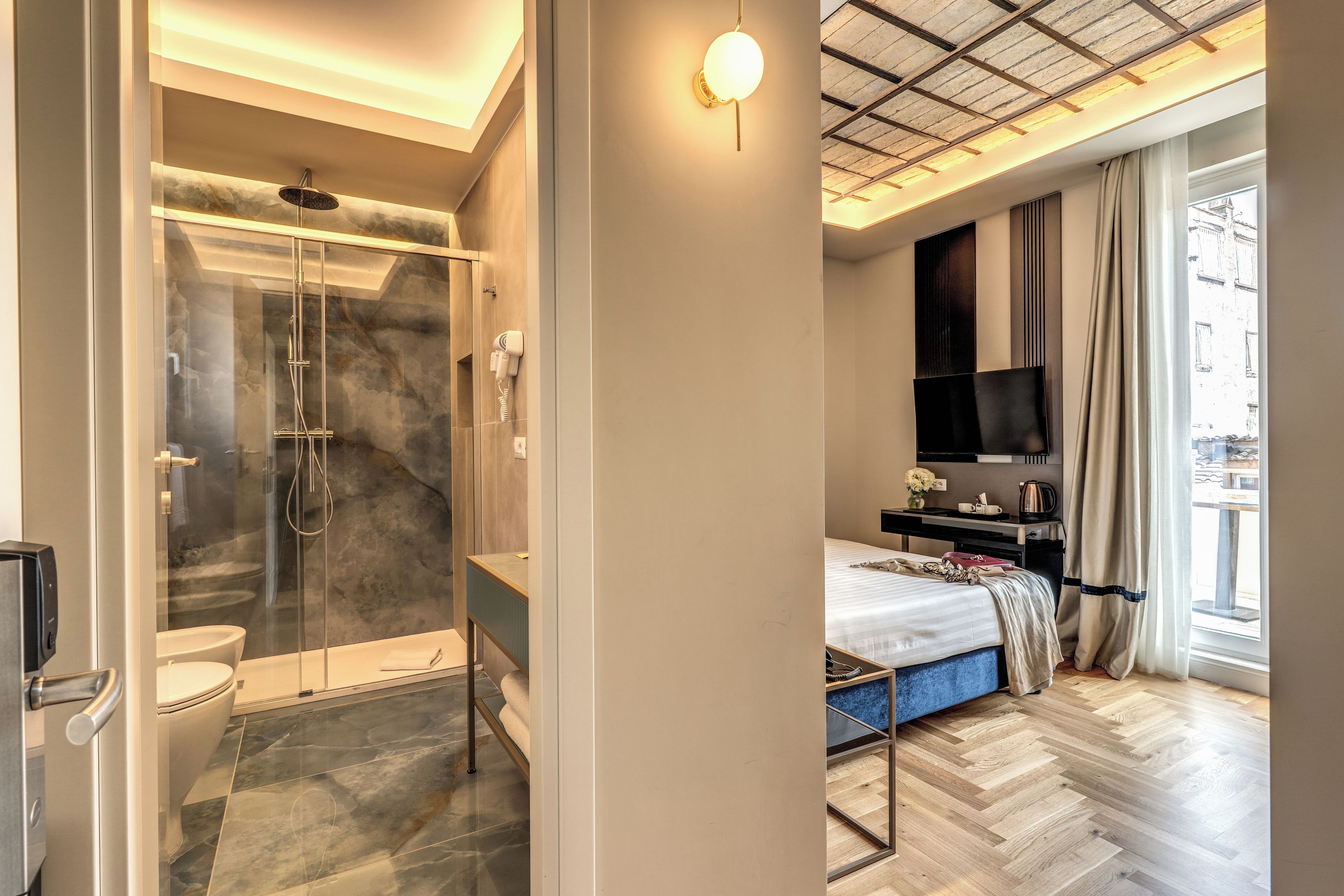A modern bathroom with a glass-enclosed shower, a toilet, and a vanity.