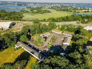 Set amidst lush greenery and a serene body of water, this commercial facility offers a tranquil atmosphere.
