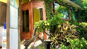 A traditional building with a wooden door and a covered porch. - Casa del Lago Lodging House (Puerto Ayora)