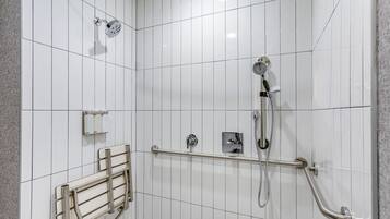A modern bathroom with white tiled walls, a shower with a handheld showerhead, a handheld showerhead, a handheld showerhead, a handheld showerhead, a handheld showerhead, a handheld showerhead, a handheld showerhead, a handheld showerhead, a handheld showerhead, a handheld showerhead, a handheld showerhead, a handheld showerhead, a handheld showerhead, a handheld showerhead, a handheld showerhead, a handheld showerhead, a handheld showerhead, a handheld showerhead, a handheld showerhead, a handheld showerhead, a handheld showerhead, a handheld showerhead, a handheld showerhead, a handheld showerhead, a handheld showerhead, a handheld showerhead, a handheld showerhead, a handheld showerhead, a handheld showerhead, a handheld showerhead, a handheld showerhead, a handheld showerhead, a handheld showerhead, a handheld showerhead, a handheld showerhead, a handheld showerhead, a handheld showerhead, a