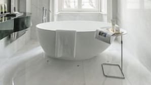 A modern bathroom with a freestanding bathtub, a vanity with a mirror, and a window with sheer curtains. - Vista Palazzo, Lago di Como (Como)