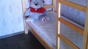 A bunk bed with a teddy bear on the lower bunk. - Yourhostel La Femme (Kyiv)