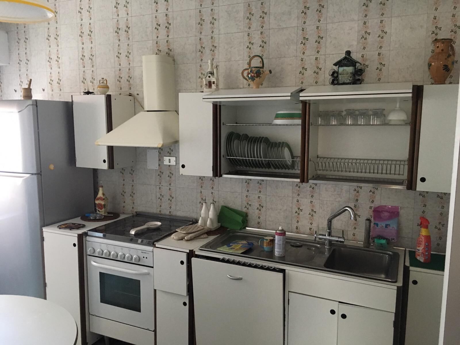 full-sized fridge, oven, stovetop, cookware/dishes/utensils