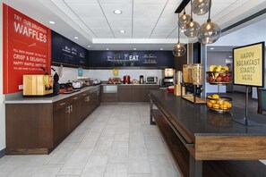 A modern kitchen with a waffle station, a coffee machine, and a fruit bowl. - Hampton Inn & Suites D'Iberville Biloxi (D'Iberville)