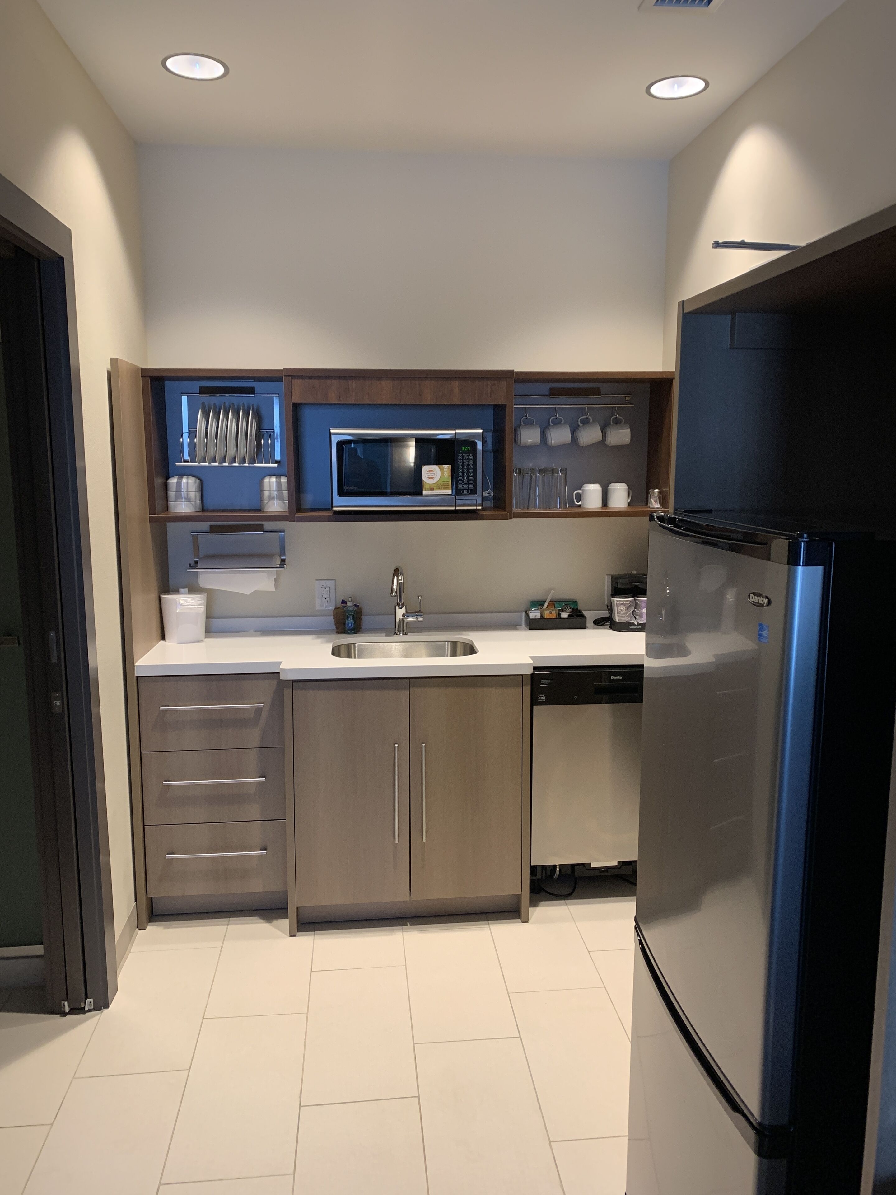A modern kitchen with a built-in microwave, stainless steel appliances, and a dishwasher.