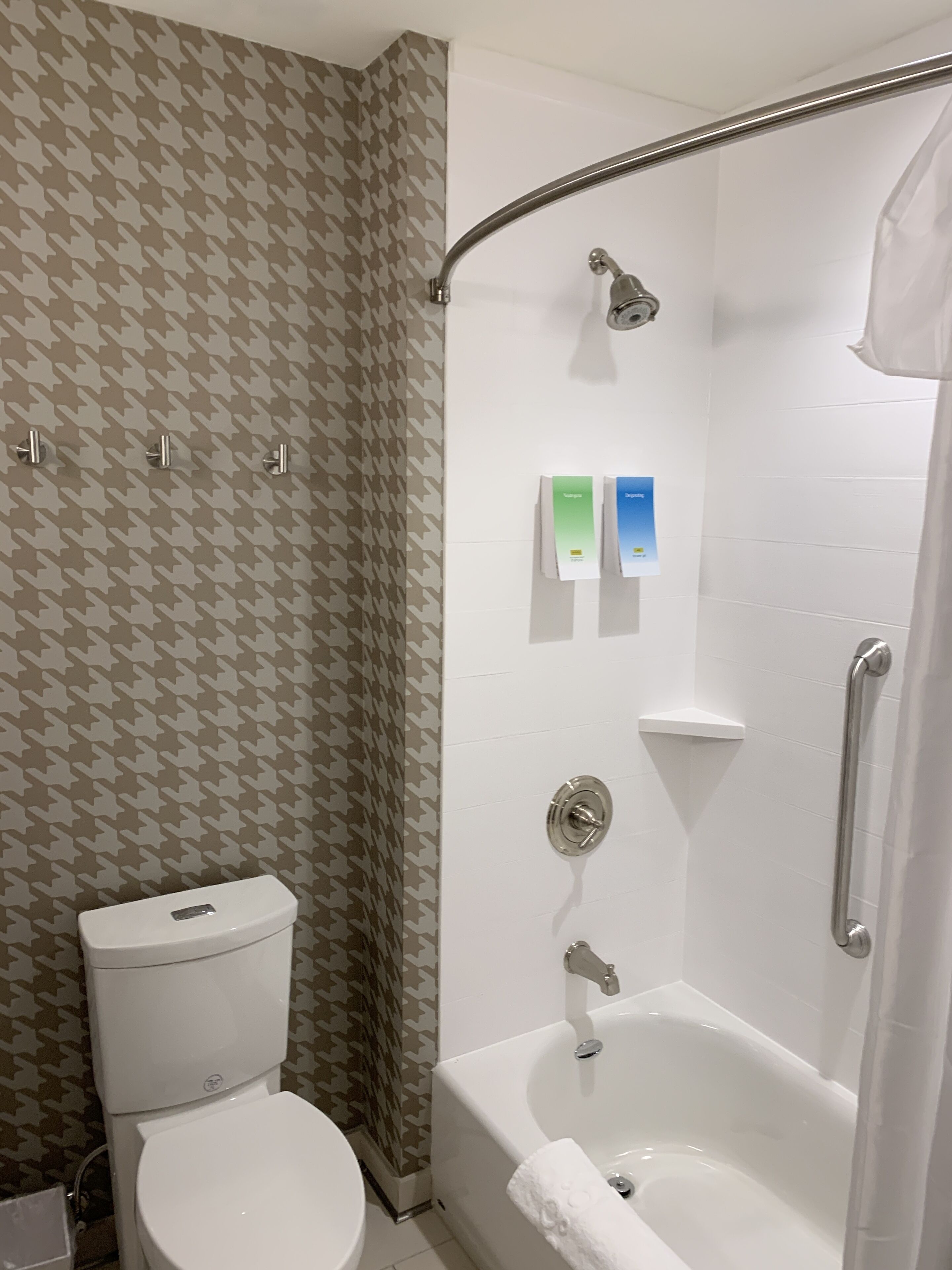A bathroom with a toilet, a shower, and a bathtub.