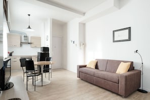 Departamento, 1 habitación | Área de sala de estar | Televisión de pantalla plana 
