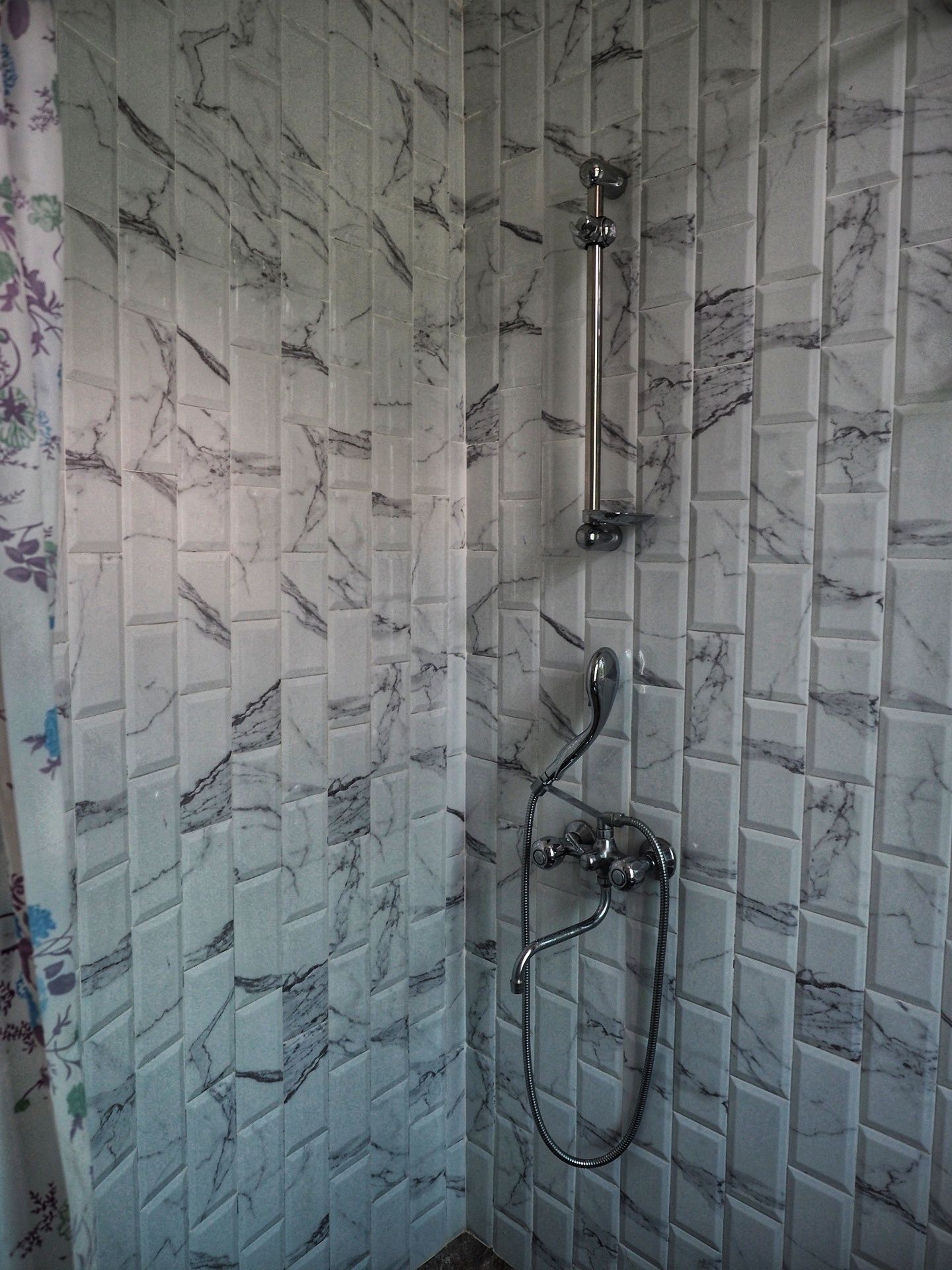 A bathroom with a shower and a toilet.