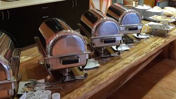 A buffet setup with multiple self-service food dispensers.