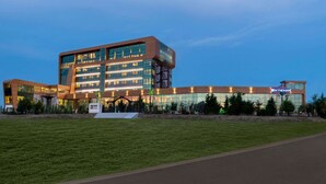 A modern hotel with a glass facade, multiple floors, and a prominent 'WYNDHAM' sign.