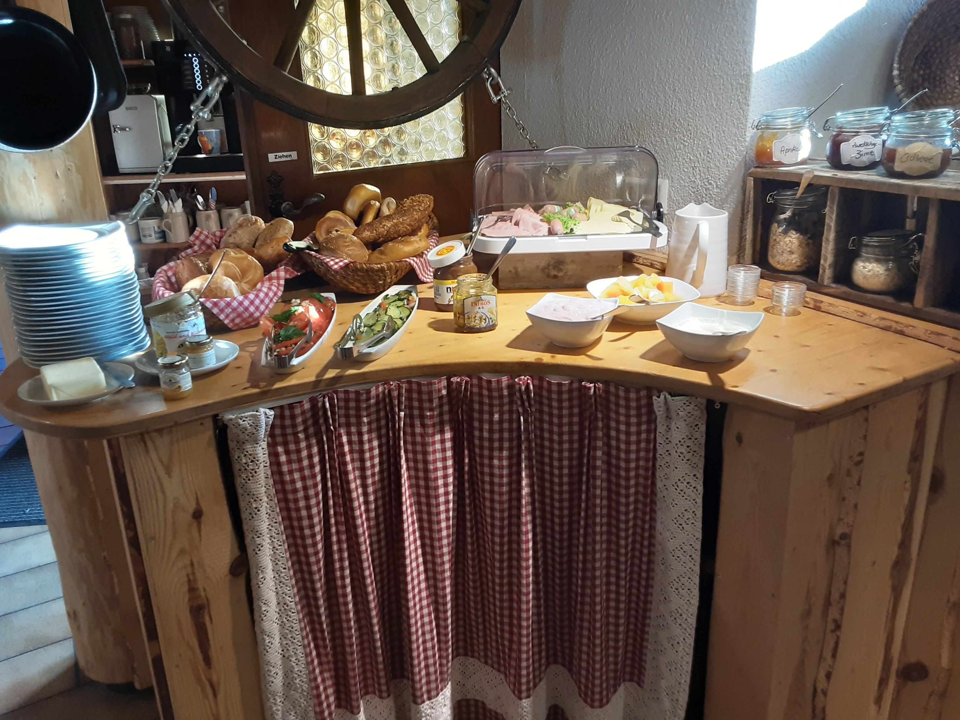 A breakfast buffet with various food items and condiments.