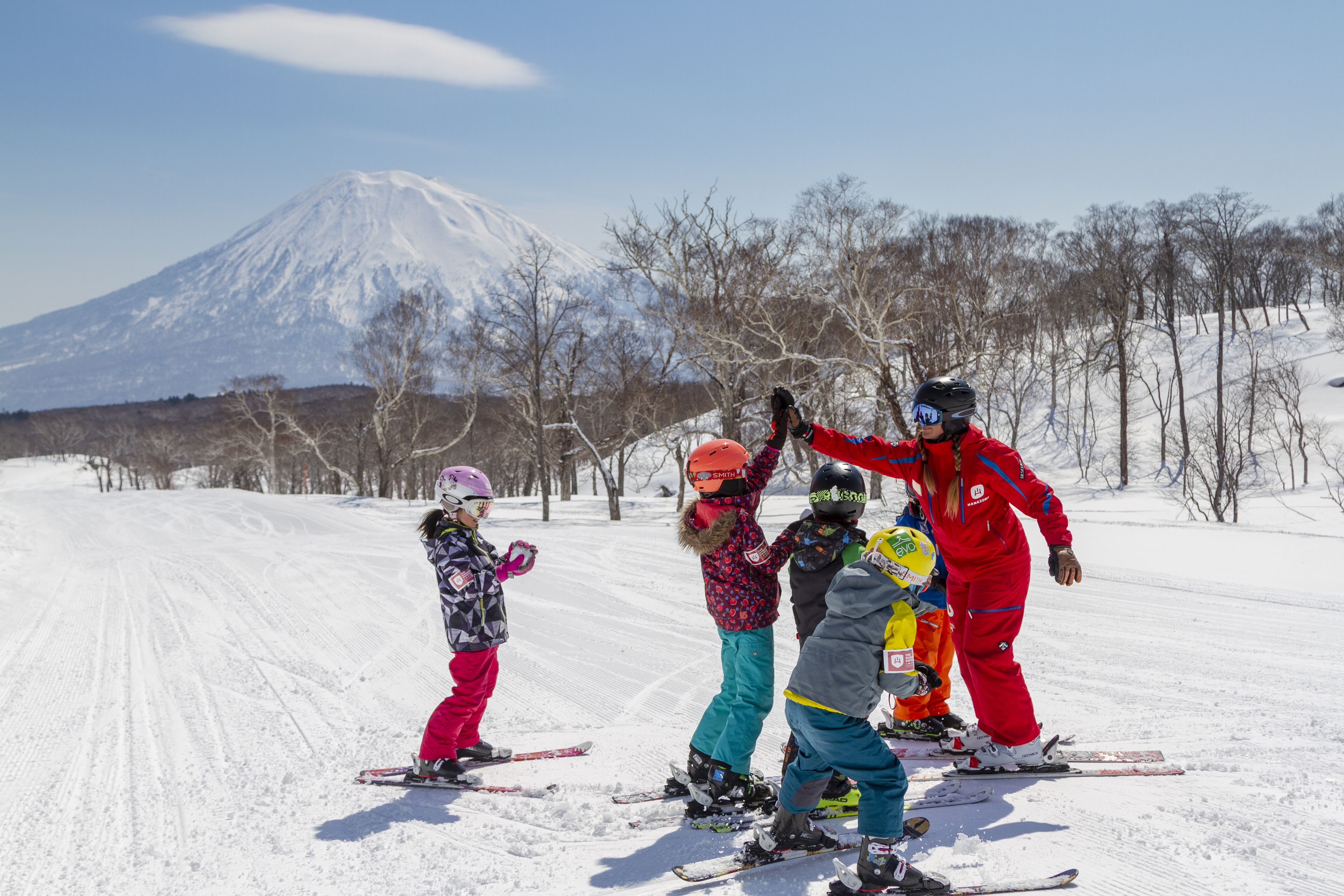 A snowy ski slope with a mountain in the background.