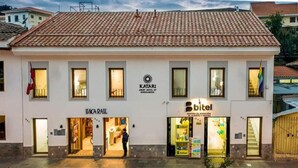 A building with a tiled roof, a sign for 'Katari Apartment Hotel at Corrianka', and a 'bitel' service center.