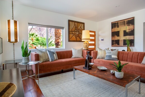 A modern living room with a sofa, coffee table, and decorative items.