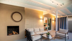 A modern living room with a sofa, armchairs, a coffee table, and a fireplace. - The Exclusive Presidential House (La Quinta)
