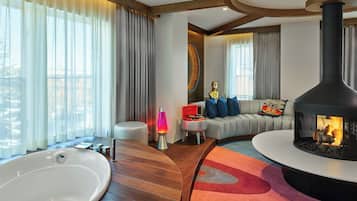 Presidential Suite, 1 King Bed, Fireplace (Wow Suite) | Living room | 50-inch flat-screen TV with cable channels, TV, books