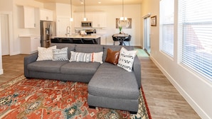 A modern kitchen with white cabinets, a stainless steel refrigerator, and a microwave. - Luxury Zion Escape sleeps 12 *Private Hot Tub* (Washington)