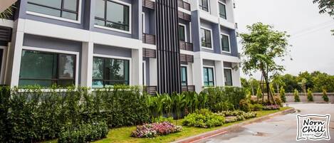 A multi-story building with a modern architectural design, featuring large windows and balconies.