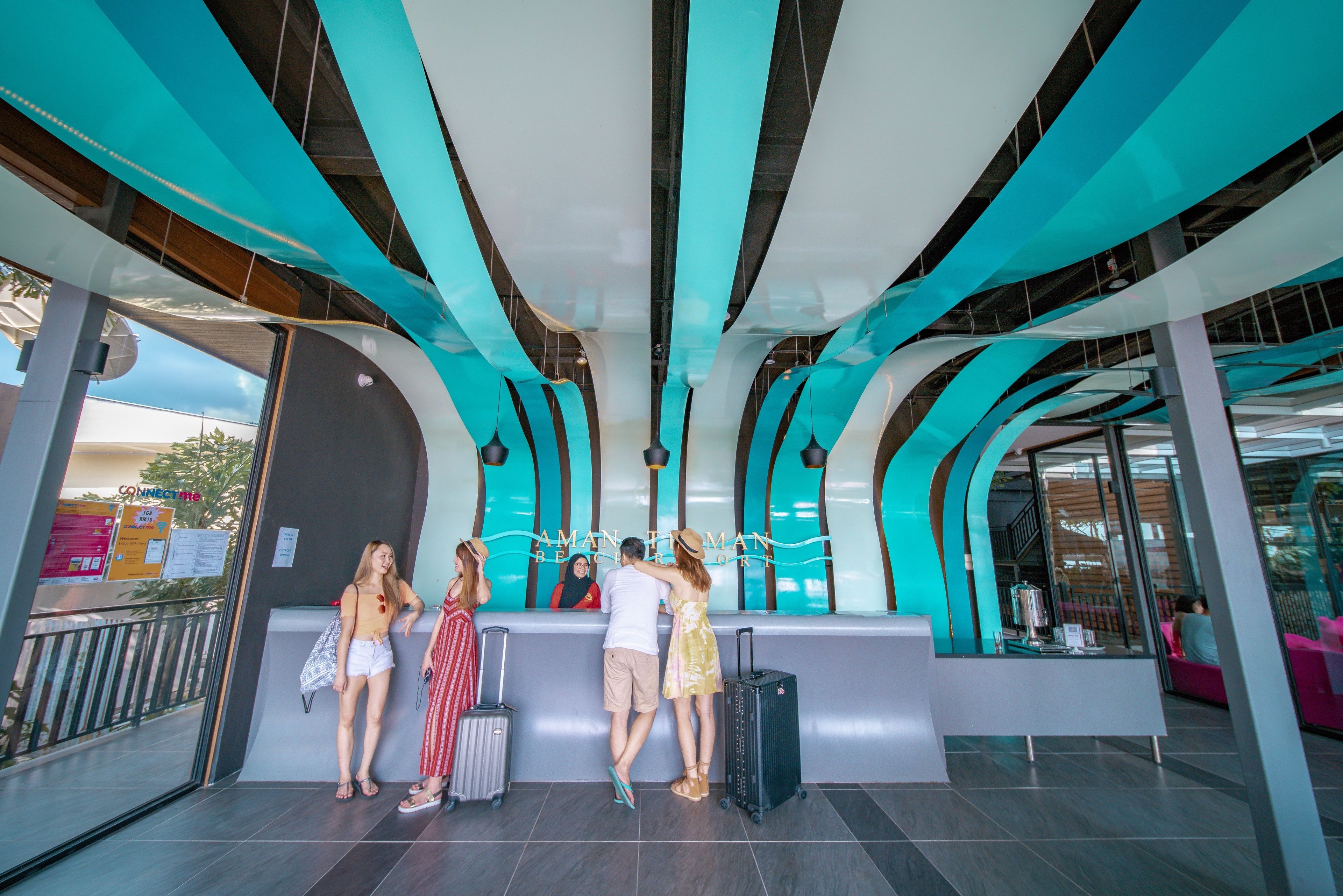 A modern lobby with a curved reception desk, glass partitions, and a view of the outside.