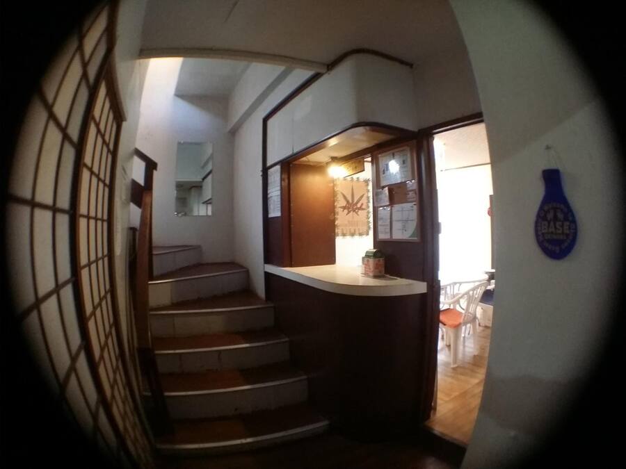 Una escalera que lleva a un rellano con una barra y una puerta.
