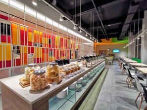 A buffet setup with various food items and utensils. - Zuri Express Banjarmasin (Banjarmasin)